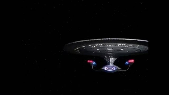 Still: the Enterprise-D on black, saucer lights on